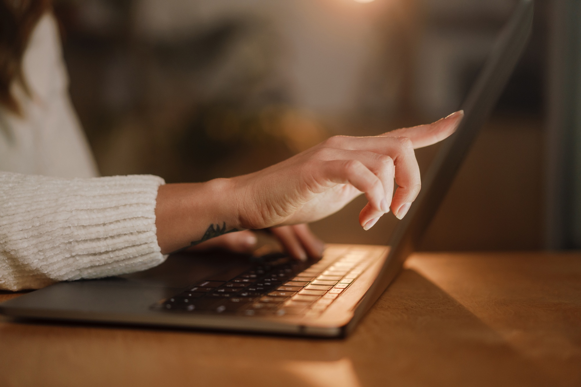 Female hands typing on a laptop