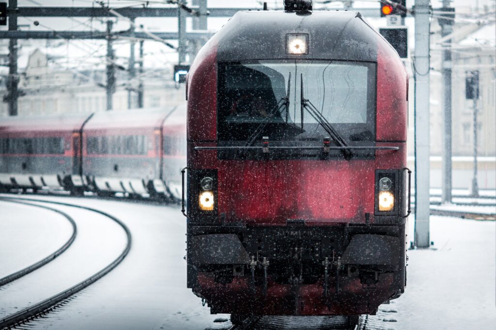 Moving train on the track with snowflakes