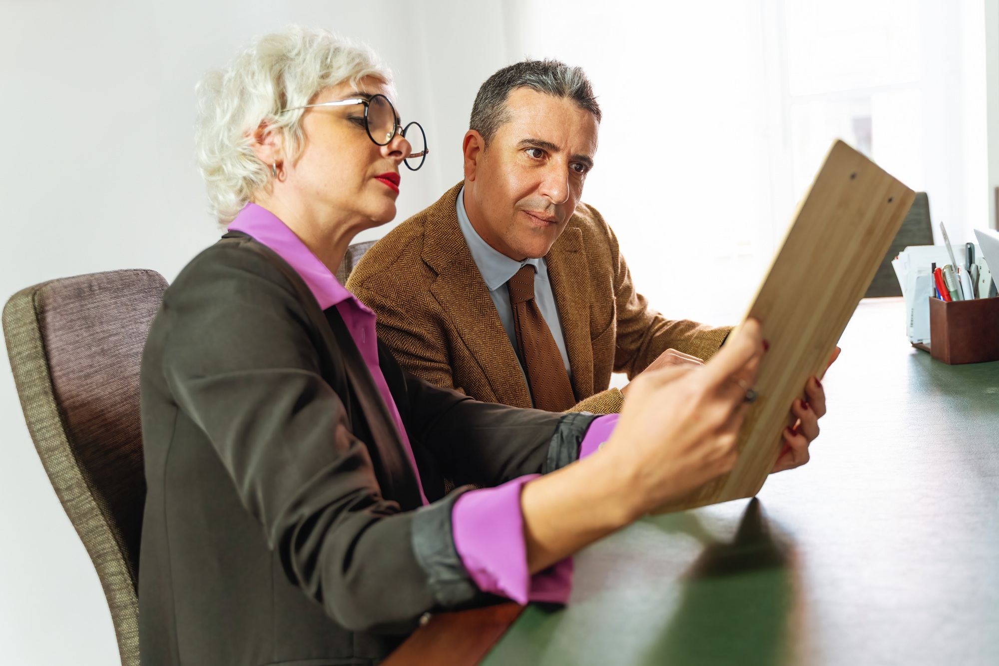 Business Discussion Meeting or Married Couple with Notary - Reviewing Documents and Contracts